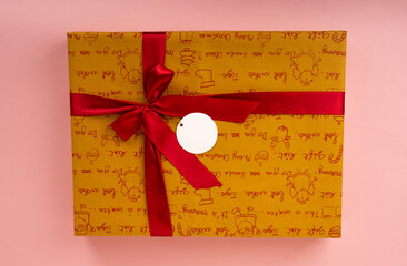 wrapped colorful gift on pink background