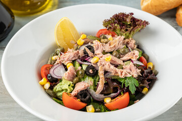 Tuna salad in a white porcelain bowl. Healthy food concept