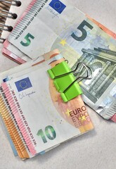 euro bills lie on a paper notebook