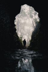 a man is standing in a dark cave on madeira