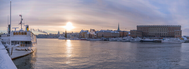 The bay Strömmen moored commuting steam boats at the pier Strömkajen backlight a pale snowy winter day in Stockholm, old, ship, modern, landscape, famous, blue, tourism, city, skyline, water, river