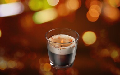 Beautiful aroma candle with fire on the desk