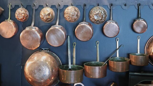 Copper Pots and Pans and other Kitchen Utensils in an Antique Metal Kitchen