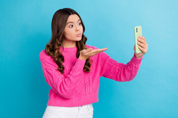 Photo of young blogger schoolgirl teen aged send air kiss hand pouted lips take shot smartphone...