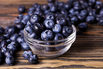 Ripe blueberries in glass saucepan