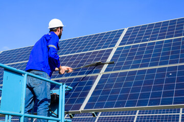cleaning solar panel. Worker cleaning solar panel