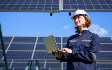Energy Engineering portrait with solar panel at solar farm. Solar farm with engineer workers...