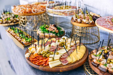 Exquisite wedding table with snacks, Cossack table. Appetizer table arranged for a festive dinner. Banquet Table in restaurant served with different meals.