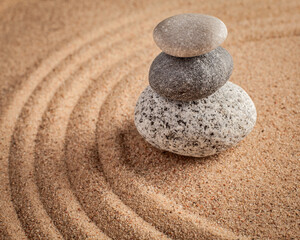 Fototapeta na wymiar Japanese Zen stone garden - relaxation, meditation, simplicity and balance concept - pebbles and raked sand tranquil calm scene