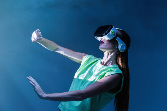 Woman playing VR game in neon light