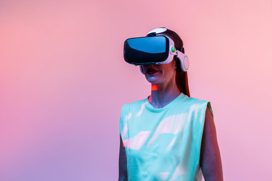 Woman playing VR game in neon light