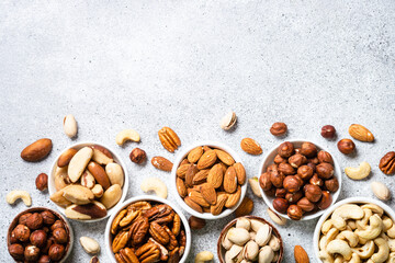 Assortment of nuts in bowls. Cashew, hazelnuts, pecan, almonds, brazilian nuts and pistachios.