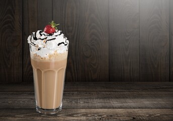 Tasty sweet iced latte with cream in glass