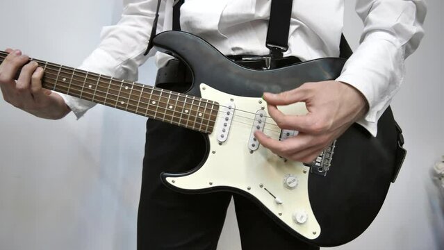 A young left-handed musician plays the guitar. Relax with song and music. a man has fun playing the acoustic guitar.Lifestyle concept.