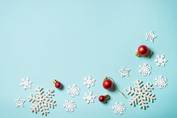 Christmas composition with holiday decorations on blue.