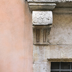Italy, Perugia, summer 2022. Fragment of wall with pink plaster and architectural elements on the...