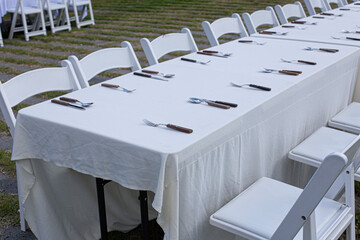 tables being set up for a wedding reception.