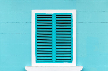 Colonial style turquoise wooden facade with window in Santa Ana Hill, Guayaquil, Ecuador.