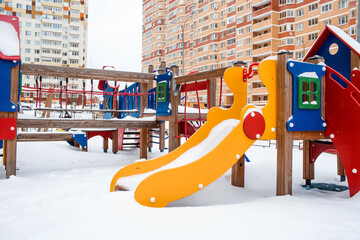 A new children's playground in the courtyard of a multi-storey residential building in winter. A new neighborhood. Moscow region. Prominent. Boulevard Green alleys.