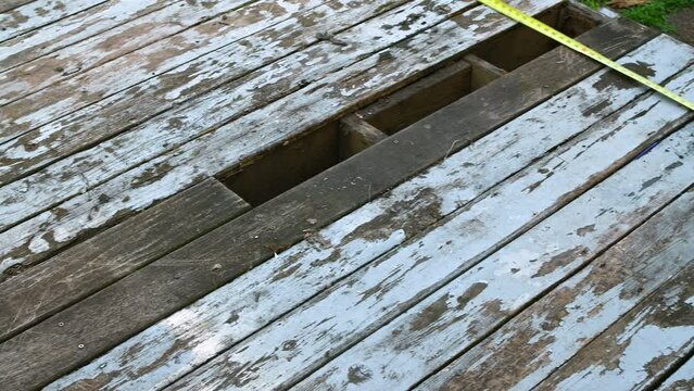 Old wooden deck with missing wood boards. Space for text. 4k video