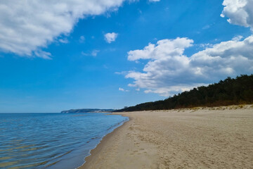 View of the Baltic sandy coast. Splashes of water. Sunny day on the beach. Seascape. Change in nature, climate.
