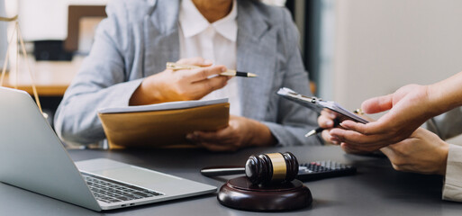 Male lawyer working with contract papers and wooden gavel on tabel in courtroom. justice and law ,attorney, court judge, concept.