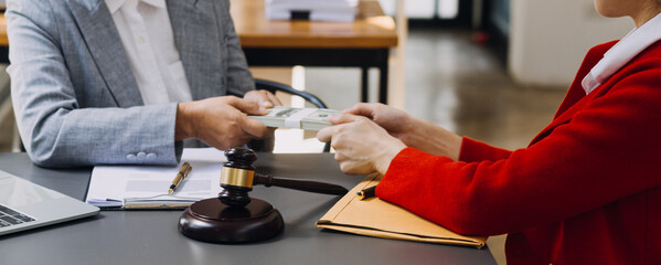 Male lawyer working with contract papers and wooden gavel on tabel in courtroom. justice and law ,attorney, court judge, concept.
