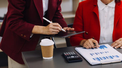 Businessman and team analyzing financial statement Finance task. with smart phone and laptop and...