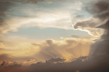 The sun's rays passing through the clouds and shining form an interesting light pattern against the sky. Space for text, Selective focus.