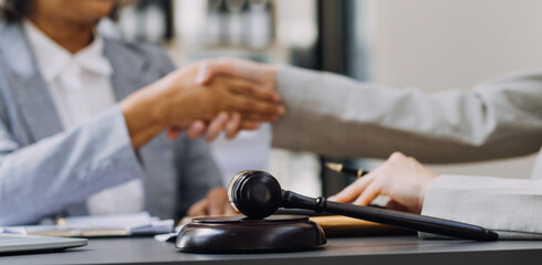 law books and scales of justice on desk in library of law firm. jurisprudence legal education concept.
