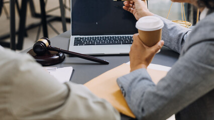 law books and scales of justice on desk in library of law firm. jurisprudence legal education concept.