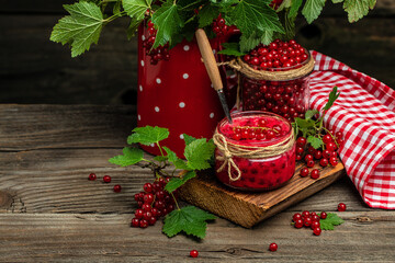 red currant jam in jar. Canned fresh berries on a wooden background. banner, menu, recipe place for text