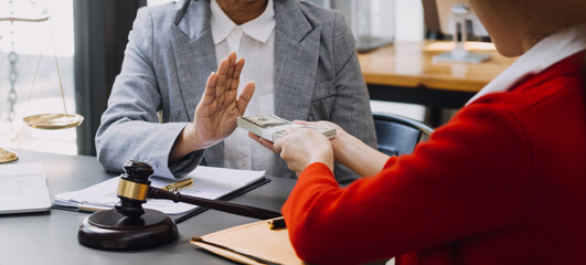law books and scales of justice on desk in library of law firm. jurisprudence legal education concept.