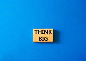 Think big symbol. Wooden blocks with words Think big. Beautiful yellow background. Business and Think big concept. Copy space.