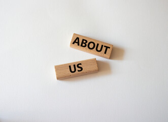 About us symbol. Wooden blocks with words About us. Beautiful white background. Business and About us concept. Copy space.