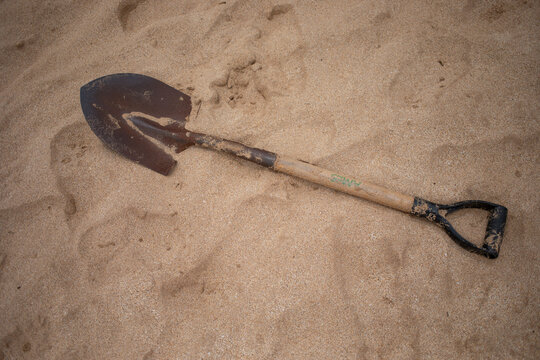 Garden shovel on sand; Maui, Hawaii, United States of America