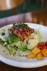 Fresh green lettuce salad with salmon