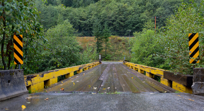 Weathered infrastructure wet from the rain along BC Highway 5 going North from Hope to the Coquihalla Summit on a rainy morning; British Columbia, Canada