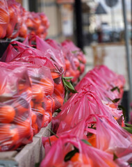 Mandarins in plastic bag displayed for sale on the street