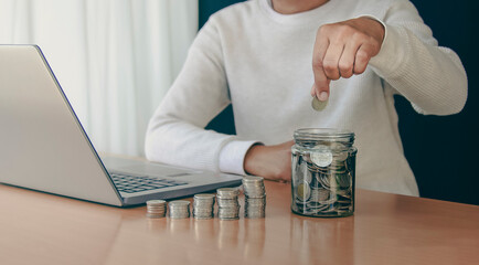 woman hand putting money coin into piggy for saving money wealth and financial concept.