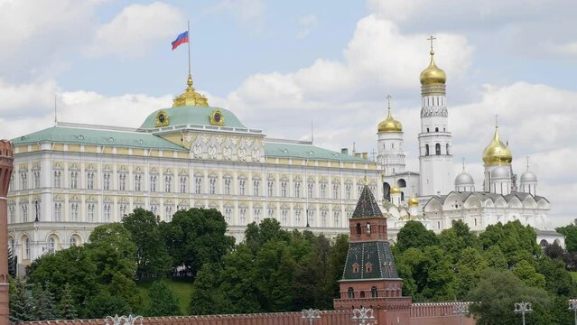 View of the Moscow Kremlin from the Moscow river. Red brick towers and Bell Tower Of Ivan The Great.
