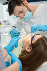 Dentist busy injecting local anesthetic to client before dental procedure