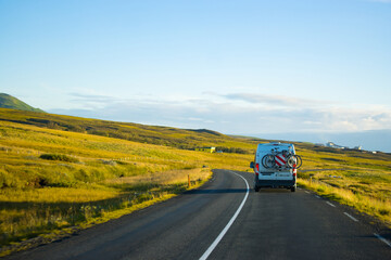 Family vacation cycle on a bus , road trip in a highway, green peaceful travel Eurotrip Iceland