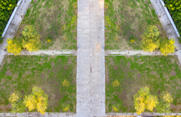 Perpendicular aerial view on a park with grass and roads.