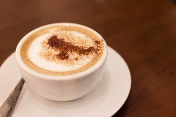 Hot coffee sprinkled with cocoa powder for a delicious taste.