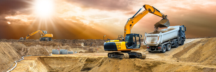 excavator ist working and digging at construction site
