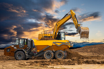 excavator ist working and digging at construction site
