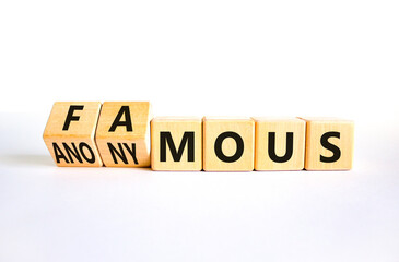 Famous or anonymous symbol. Concept word Famous and Anonymous on wooden cubes. Beautiful white table white background. Business famous or anonymous concept. Copy space.