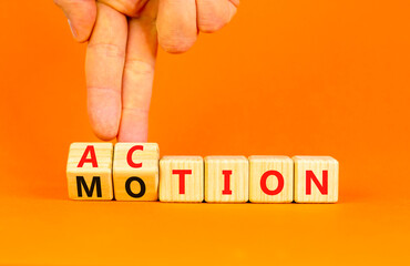 Action or motion symbol. Concept word Motion and Action on wooden cubes. Businessman hand. Beautiful orange table orange background. Business and action or motion concept. Copy space.