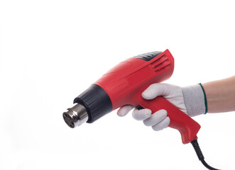 Building hair dryer, red. On an isolated white background. With a human hand in a white glove.